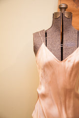 Vintage 1930s satin pink gown featuring a smooth V-neckline and delicate spaghetti strap.