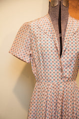 Collar and bodice of vintage 40s day dress, pinkish ivory with blue, brown motifs, rhinestone buttons.