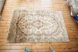 Vintage Ivory Kerman Persian rug displaying baroque rococo motifs and subtle blue abrash.