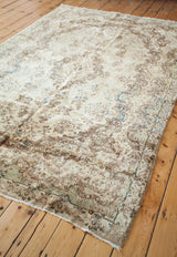Vintage Kerman rug corner, showing classic baroque motif, abrash blue, and sea foam green.