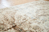 Low pile ivory Kerman rug with golden abrash and subtle blue baroque motifs.