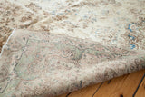 Folded corner of the Kerman rug, displaying its hand-knotted weave and subtle pastel tones.