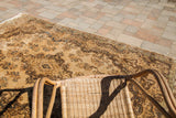 Rococo floral motifs with subtle blue and golden abrash on vintage Kerman rug.