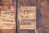 Worn early 1900s No Mark Bureau and Railway labels on the antique trunk's dark wood planking.