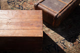 Aged wooden top of the vintage cedar blanket chest with visible grain and marks.