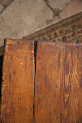 Vintage trunk's warm brown wood surface, natural grain, and rustic vertical joint.