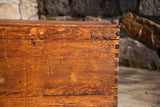 Vintage cedar trunk corner with rich wood grain and exposed dovetail joints.