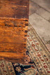 Rustic wood grain and exposed dovetail joints of the vintage cedar blanket chest.