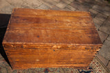 Exposed dovetail joints on the corner of the vintage cedar chest with aged wood.