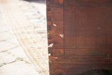 Vintage cedar blanket chest side, exposed dovetail joint, rich reddish-brown wood.