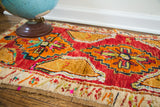 Plush pile, whimsical orange medallion, and colorful short fringe of this vintage Turkish rug.