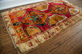 Plush pile and colorful hand-knotted fringe of a whimsical vintage Turkish rug.
