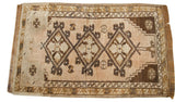 Muted vintage Turkish rug with geometric triple medallion in coffee, bronze, and blanched beige.