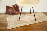 Blanched Turkish runner displaying pastel central medallion and plush pile.