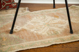 Geometric center medallion and blanched pastel tones of a plush Turkish runner.