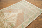 Pastel green wavy border and blanched plush pile detail of the Turkish runner.