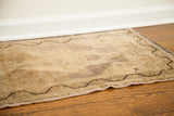 Dark meandering border and faded mauve field on this vintage Turkish rug.