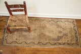 Faded vintage Turkish rug runner showing deep mauve hints and dark meandering border.