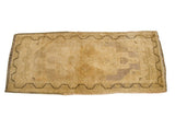 Faded Turkish runner with light beige field, dark meandering border, mauve hints. 1'9
