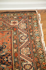 Worn fringe and intricate Herati motif in rust, navy, and beige antique Feraghan rug border.