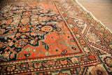 Antique Feraghan rug corner reveals navy Herati motif and distinctive spandrel lines.