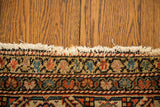 Soft fringe and intricate multi-colored border of an antique Feraghan rug.