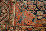 Antique Feraghan rug corner spandrel with rich red field and navy Herati motif.