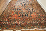 Antique Feraghan rug corner showing unique spandrel design and elaborate borders in navy, terracotta.