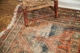 Tattered fringe and worn texture revealing muted red, blue, and beige tribal patterns.