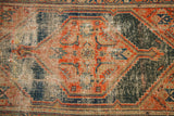Patinaed pile texture revealing faded indigo and terracotta tribal motifs.