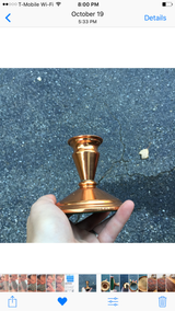 Vintage copper candlestick holder with a shiny, reflective finish.