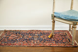Vintage Deep Blue Sarouk Persian runner rug with ornate floral pattern and tattered aesthetic.