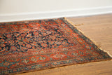 Early 20th-century Herati design border with tattered fringe on a blue Kurdish runner.