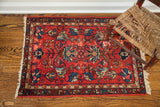 Corner detail of diminutive vintage Persian rug, cherry red small-scale floral design, aged patina.