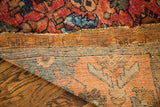 Detail of a Lilihan Sarouk rug, showcasing worn red pile and striped hand-woven foundation.