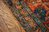 Worn selvedge and geometric border in teal, rust of a Lilihan Sarouk rug.