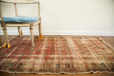 Antique rug featuring unusual repeating floral design, abrash, faded red, and beige tones, 3'3