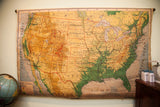 Vintage United States pull down map, circa 1950s, featuring rich yellow, green, and blue hues.