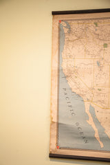 Vintage map detail showing Pacific Ocean, patterned border, and water-stained right edge.