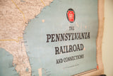Vintage Pennsylvania Railroad map's light blue field, red Keystone logo, and aged paper edge.