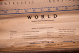 Vintage Denoyer Geppert World map's geographic editors, publisher details, and peeling tape.