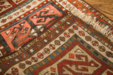 Rich geometric patterns and varied hues on an antique Caucasian rug border.