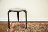 Vintage Mid Century Alvar Aalto side table with striped top and dark, chipped bentwood legs.