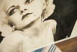Vintage Jean Harlow street art close-up, showing lips, beauty mark, and earring.