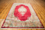 Plush red Kerman pile, intricate cream, blue, pink floral border and fringe.