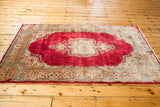 Ornate Cyrus Crown Kerman rug with a vibrant cochineal red field and intricate floral motifs.