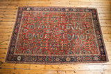 Antique Fereghan carpet, rust ground, dense floral pattern in green, gold, blue, 7x10.