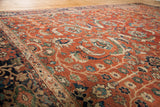 Rich earth-tone rust field with vibrant blue and green floral palmettes.
