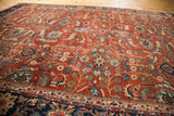 Antique Fereghan carpet, rich rust ground with intricate blue, green, gold floral and vine patterns.