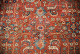 Earth tone rust ground with saturated blue, green, gold stylized floral and animal motifs.